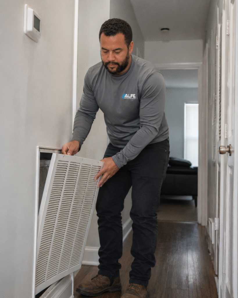 Certified Alfe Construction technician performing AC maintenance on a residential air conditioning unit in Orlando, Central Florida
