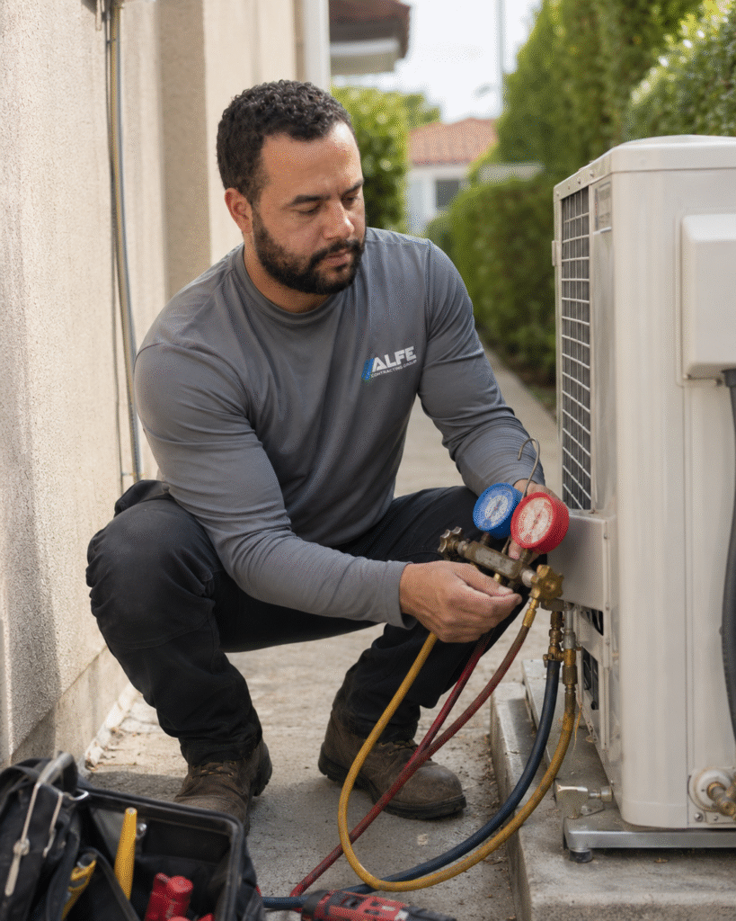 Certified Alfe Construction technician repairing an air conditioning unit at a residential home in Orlando, Central Florida