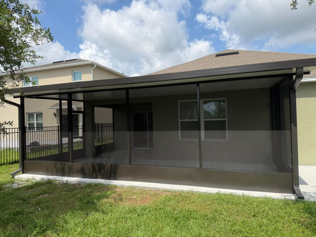 Bronze screen enclosure with solid insulated roof on a Central Florida home