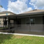 Bronze screen enclosure with solid insulated roof on a Central Florida home