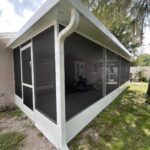 White-frame screen room with insulated roof in Central Florida