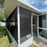 Screened patio enclosure with gutter and insulated roof by ALFE