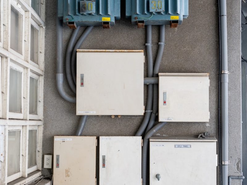 Electrical boxes and transformers mounted on a wall.